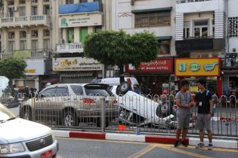 A street scene with damaged vehicles during the filming of the movie "Line Walker 2" near the Sule pagoda in Yangon on February 26, 2019. Photo: Thet Ko/Mizzim