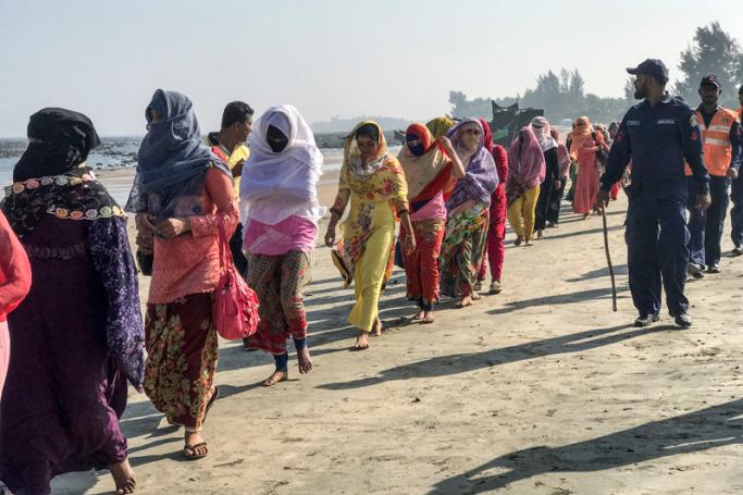 Coast guards escort Rohingya refugees following a boat capsizing accident, in Teknaf on February 11, 2020. Photo: AFP