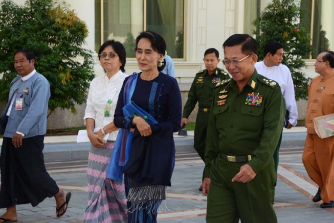Myanmar military commander-in-chief Senior General Min Aung Hlaing and Myanmar opposition leader Aung San Suu Kyi arrive to attend a high-level meeting at the President's resident office in Nay Pyi Taw on 31 October 2014. Photo: MNA