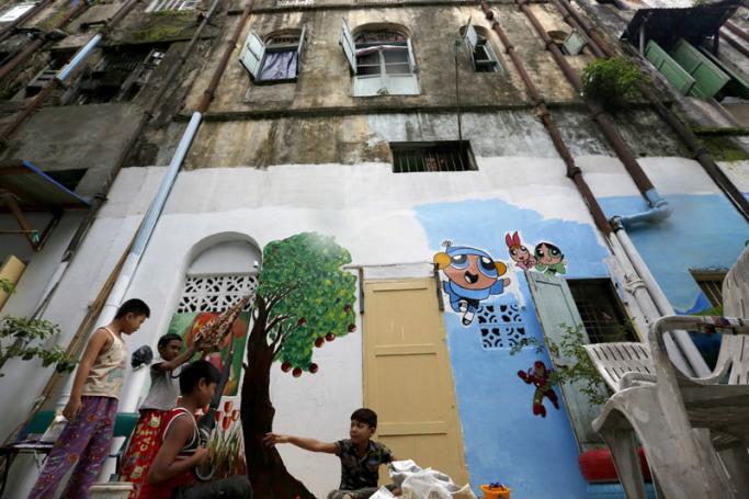 Children play near the painting at the backstreet in Yangon. Photo:Nyein Chan Naing/EPA