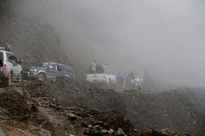 A picture made available on 21 October 2016 shows cars drive on a narrow hill-side road near Tedim city, Chin State, Myanmar, 12 October 2016. Photo: Nyein Chan Naing/EPA