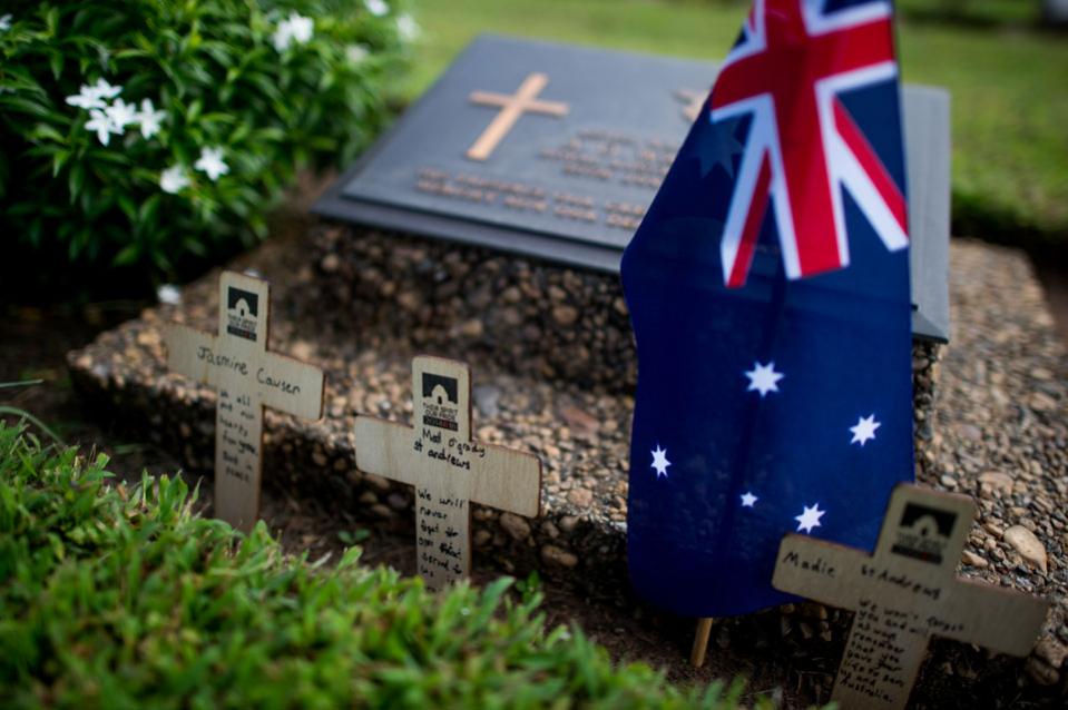 An Australian flag is planted on a tomb of a soldier during a ceremony marking the 100th anniversary of the end of the World War I at Taukkyan War Cemetery, a war memorial for  Allied soldiers from the British Commonwealth in Yangon on November 11, 2018. (Photo by Ye Aung Thu / AFP)