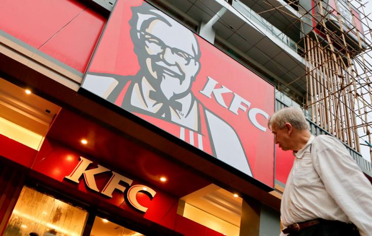 A man walks pass in front of the KFC first branch restaurant in Yangon, Myanmar, 22 June 2015. KFC, US based Yum Brands, is preparing to open it's first restaurant in Yangon on 30 June 2015 as the first major American fast-food chain in Myanmar.