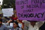 File Photo: Pakistani journalists and civil society activists hold placards against the attack on a senior journalist of a local newspaper in Karachi. / Photo: AFP