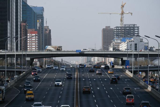 This picture shows motorists commuting on a road in the central business district in Beijing. Photo: AFP