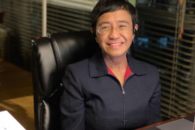This handout photo taken and released by Rappler News on October 8, 2021 shows veteran Philippine journalist Maria Ressa posing during an online interview at her home in Manila, after receiving news of her winning the Nobel Peace Prize. Handout / Rappler News / AFP