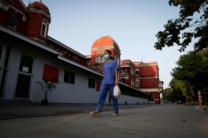 (File) A medical worker leaves after her shift ended, at Yangon General Hospital, in Yangon, Myanmar, 24 January 2021. Photo: Lynn Bo Bo/EPA