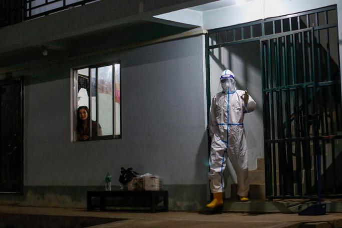 A volunteer from the Yangon Region Youth Affairs Committee (YRYAC) wearing PPE (Personal protective equipment) leaves after delivering food at a COVID-19 facility in Yangon, Myanmar, 22 September 2020. Photo: Lynn Bo Bo/EPA