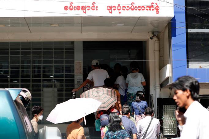 (File) People queue outside a bank in Yangon, Myanmar, 24 March 2020. Photo: EPA