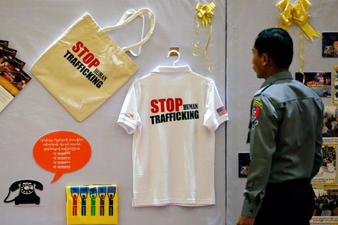A Myanmar police officer looks at Human Trafficking exhibition during a ceremony marking Anti-Human Trafficking Day in Naypyitaw, Myanmar, 13 September 2018. Photo: Hein Htet/EPA
