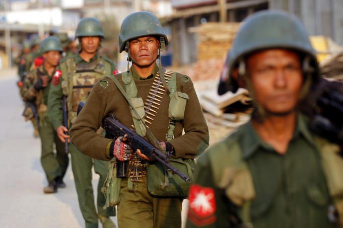 Armed military troops march as they clear the area at Chin Shwe Haw town of Kokang self-administered area, northern Shan State, Myanmar, 16 February 2015. Photo: Lynn Bo Bo/EPA
