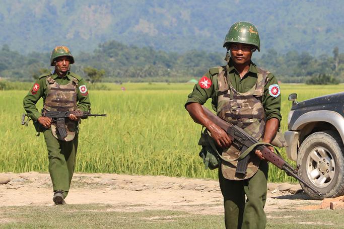 (File) Armed Myanmar army soldiers patrol a village in Maungdaw located in Rakhine State as security operation continue following the October 9, 2016 attacks by armed militant Muslim.
