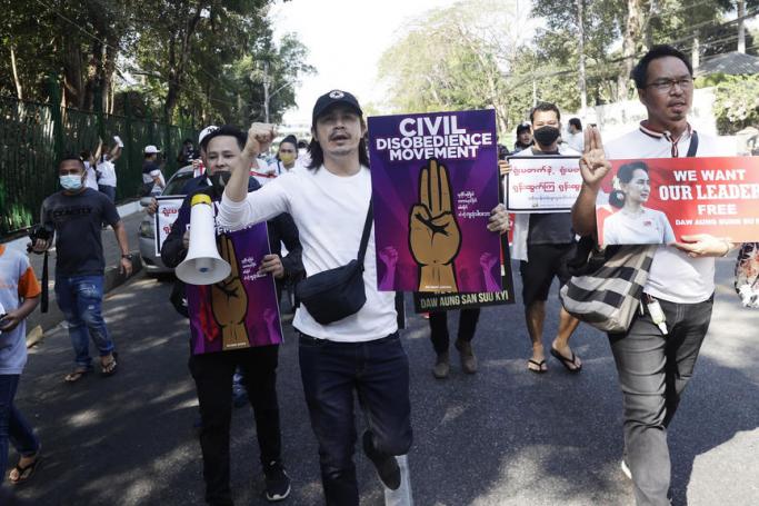 Members of the film industry hold placards as they march during a protest in Yangon, Myanmar, 10 February 2021. Photo: Lynn Bo Bo/EPA