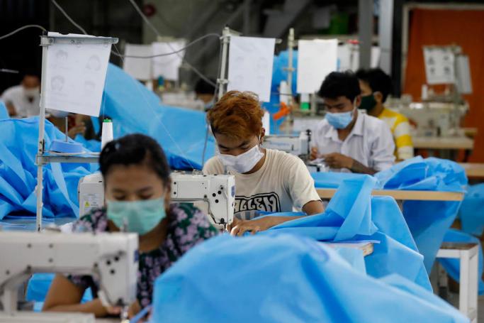 Workers make disposable surgical gown at a garment factory in Yangon, Myanmar, 02 May 2020. Photo: Nyein Chan Naing/EPA