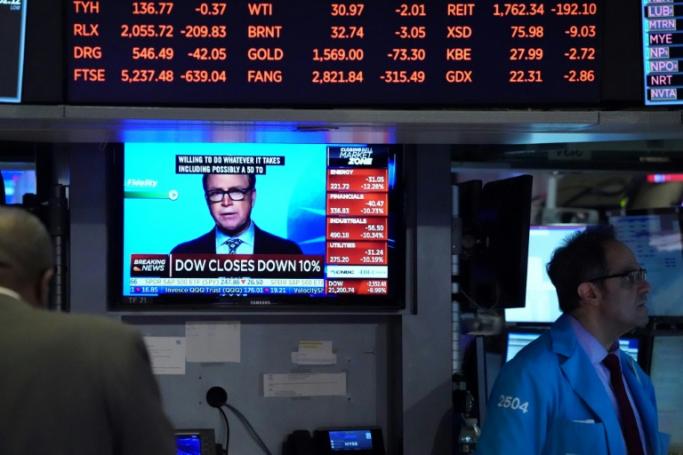The Dow suffered its worst session since 1987 on March 12, plunging 10 percent as emergency measures by central banks failed to douse mounting recession fears (AFP Photo / Bryan R. Smith)