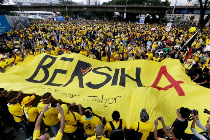Malaysian protestors unfold a banner reading 'BERSIH 4' while marching through the city streets during a BERSIH (The Coalition for Free and Fair Elections) rally in Kuala Lumpur, Malaysia. EPA/RITCHIE B.TONGO
