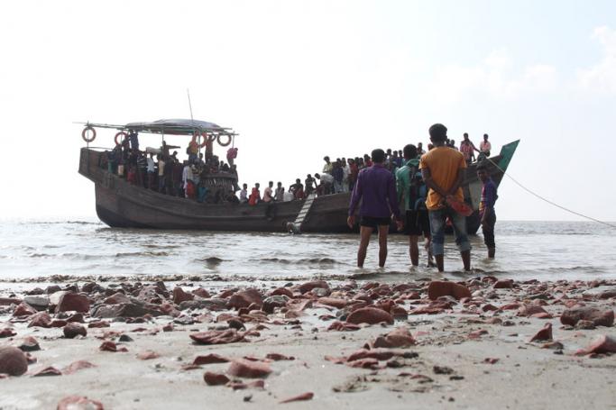 In this photograph taken on October 15, 2018, show people getting off a boat in Bhashan Char island off the Bangladeshi coast, as it was being prepared for the relocation of Rohingya refugees living in the country's south after fleeing violence in neighbouring Myanmar. Photo: Polash Shikder/AFP