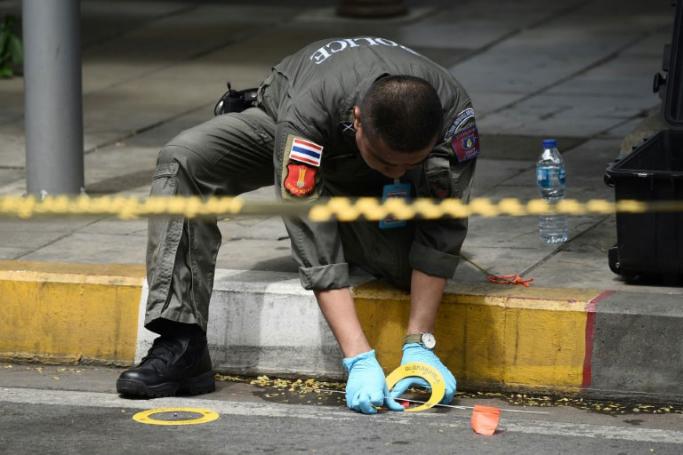 A policeman conducts an investigation at the scene of an explosion in Bangkok on August 2, 2019. Photo: Lillian Suwanrumpha/AFP