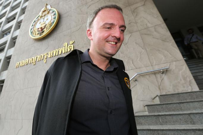 British migrant workers' rights activist Andy Hall poses for a photo as he arrives for his trial at the Bangkok South Criminal Court in Bangkok, Thailand, 24 August 2015. Photo: Narong Sangnak/EPA
