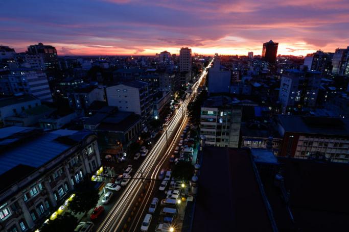A photo taken with a long exposure shows cars driving along a busy road at sunset in Yangon, Myanmar. Photo: Lynn Bo Bo/EPA-EFE
