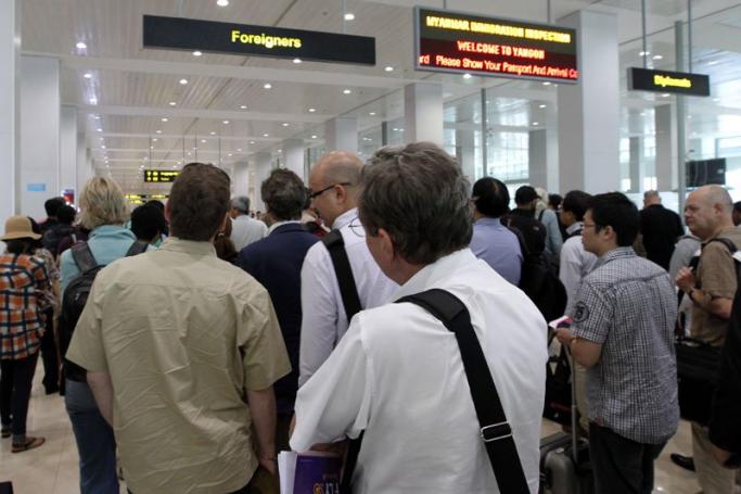 Arriving foreign tourists line up at immigration at a busy Yangon International Airport in Yangon, Myanmar, 29 March 2012. Photo: Barbara Walton/EPA
