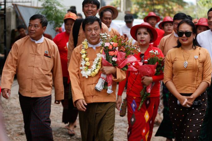Candidate of National League for Democracy (NLD) party for Tarmwe township constituency, accompanied by members of parliament and party members walks during a campaign for the upcoming by-election in the country, in downtown Yangon, Myanmar, 28 September 2018. Photo: Lynn Bo Bo/EPA