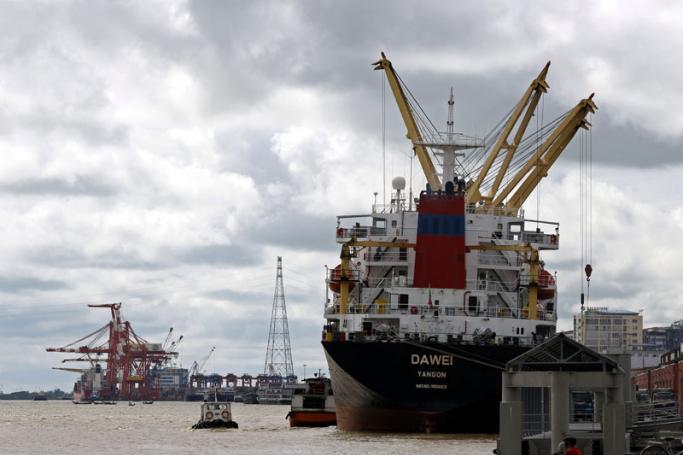 A cargo ship and port cranes are docked at the Pansodan jetty in Yangon. Photo: EPA