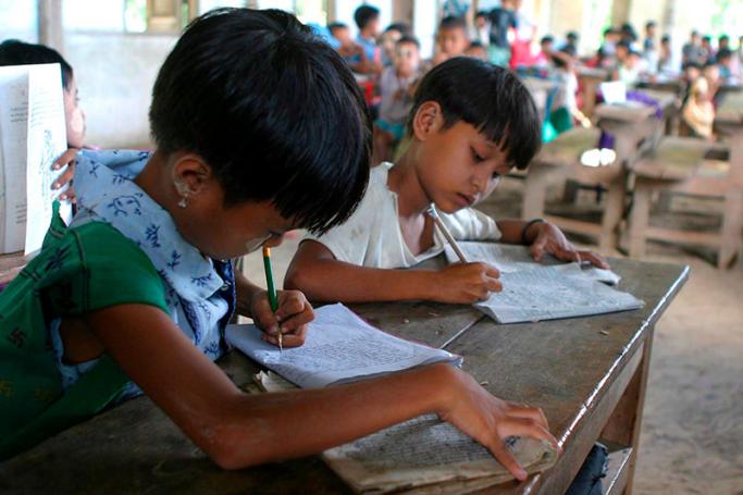 School children at work in school in the Chaung Saunt village primary school near Nay Pyi Taw. Photo: EPA
