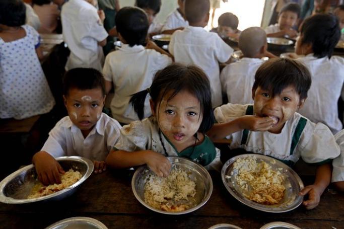 Children have lunch inside a monastery in Bago Division, Myanmar, February 19, 2014. Photo: Nyein Chan Naing/EPA
