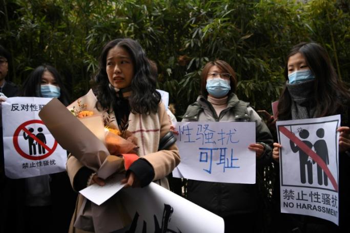 Zhou Xiaoxuan (front), a feminist figure who rose to prominence during China’s #MeToo movement two years ago, stands amongst her supporters as she arrives at the Haidian District People’s Court in Beijing on December 2, 2020, in a sexual harassment case against one of China's best-known television hosts. Photo: AFP