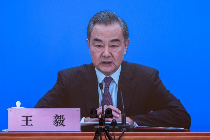 Chinese Foreign Minister Wang Yi is seen on a screen as he speaks to reporters during an online press conference, in Beijing, China, 07 March 2021. Photo: ROMAN PILIPEY/EP