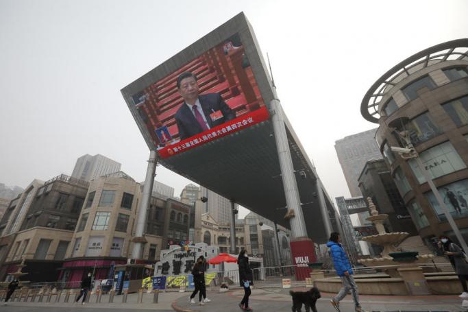 A large screen displays Chinese President Xi Jinping attending the opening session of the National People's Congress (NPC), in Beijing, China, 05 March 2021. Photo: EPA