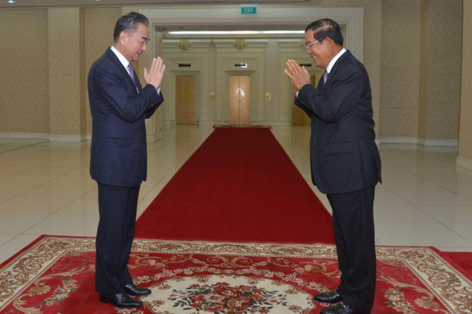 Cambodia's Prime Minister Hun Sen (R) greets China's Foreign Minister Wang Yi during a meeting at the Peace Palace in Phnom Penh on October 12, 2020. Photo: AFP