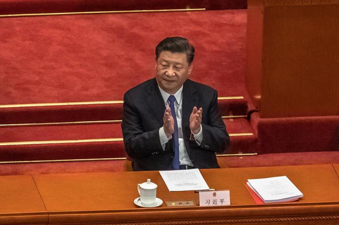 Chinese President Xi Jinping applauds after voting on the draft resolution for the controversial national security law for Hong Kong during the closing ceremony of the third session of the 13th National People's Congress (NPC) at the Great Hall of the People in Beijing, China, 28 May 2020. Photo: EPA