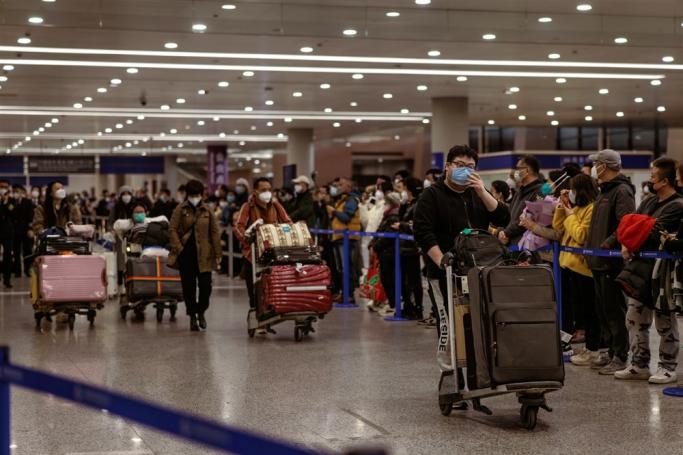 People who landed with international flight walk towards the exit of the Pudong International Airport, in Shanghai, China, 08 January 2023. Photo: EPA