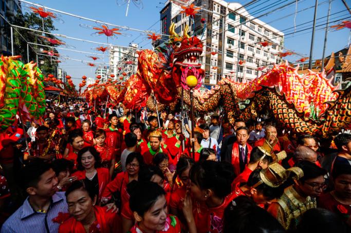 Dragon dancers march with people during Chinese Lunar New Year or Spring Festival celebration at Chinatown in Yangon, Myanmar, 16 February 2018. Photo: Lynn Bo Bo/EPA