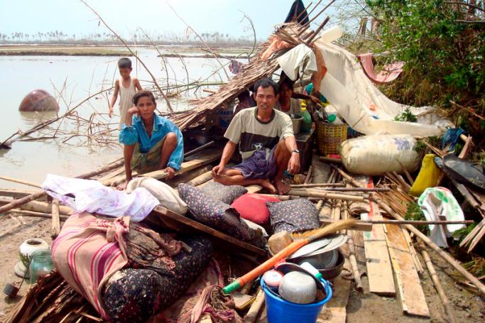 (FILE) - A Myanmar family sits on the remains of their house in Bogolay, the Irrawaddy Delta, 14 May 2008. Photo: EPA
