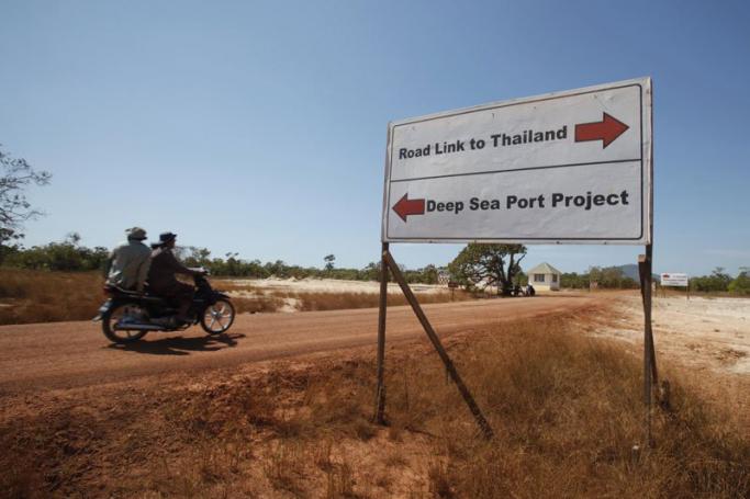 A picture made available on 31 January 2012 shows a motorbike passing near the road instruction sign of the Dawei Deep Sea Project Plan in Dawei Township, Tanintharyi Division, Myanmar, 28 January 2012. Photo: Nyein Chan Naing/EPA
