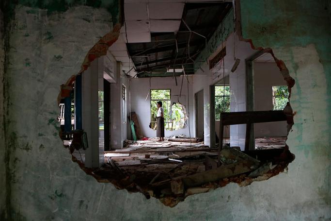 Ali Ahmed, a Muslim religious leader, stands inside the destroyed mosque at Thuye Tha Mein village of Waw township in Bago province, Myanmar, 24 June 2016. Photo: Lynn Bo Bo/EPA
