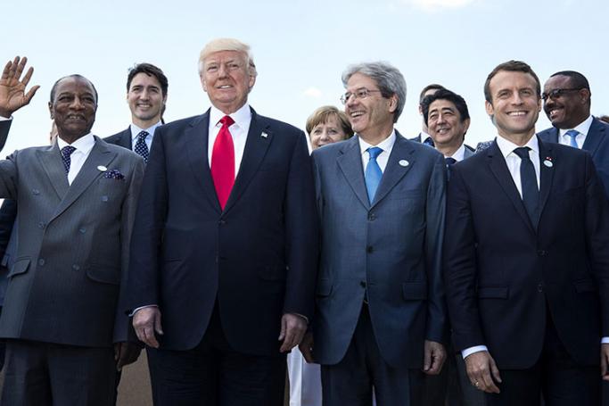 Trump troubles on tour - (Front row L-R) Guinea's President Alpha Conde, US President Donald J. Trump, Italian Prime Minister Paolo Gentiloni and French President Emmanuel Macron along with (second row) Canada's Prime Minister Justin Trudeau, (2-L), German Chancellor Angela Merkel (C) and Japanese Prime Minister Shinzo Abe (3-R) and others pose for a group photo of G7 and African leaders on the second day of the G7 Summit at the San Domenico in Taormina, Sicily, Italy, 27 May 2017. Photo: Angelo Carconi/EPA