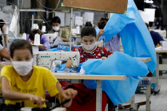  Workers make disposable surgical gown at a garment factory in Yangon. Photo: Nyein Chan Naing/EPA