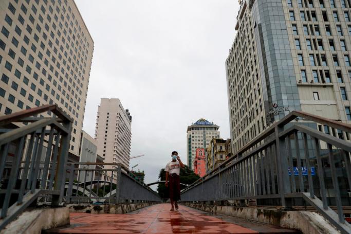 A man walks over a footbridge at downtown area despite the stay-at-home order to prevent the spread of COVID-19, Yangon, Myanmar, 21 September 2020. Photo: Lynn Bo Bo/EPA
