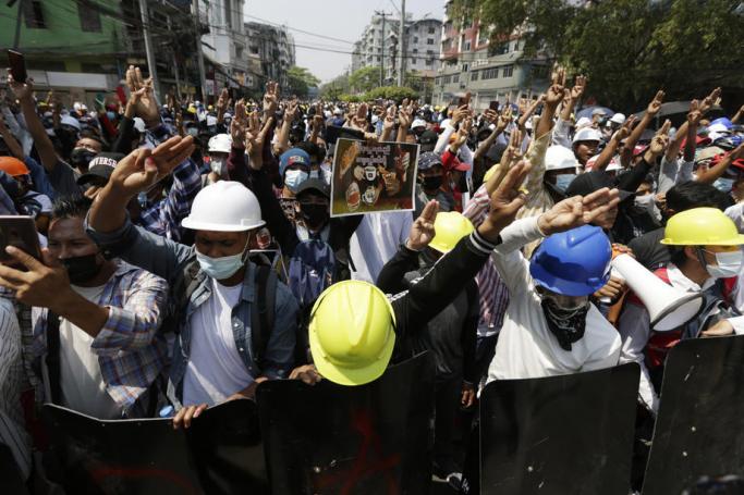 Demonstrators flash the three-finger salute during a protest against the military coup in Yangon, Myanmar, 28 February 2021. Photo: Lynn Bo Bo/EPA