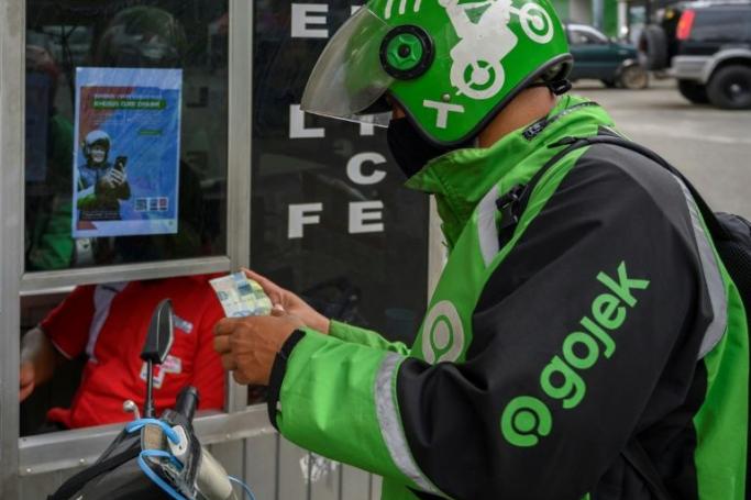 Founded in 2015, Gojek started as a motorcycle taxi app before quickly turning into a 'super-app' (AFP Photo/BAY ISMOYO) 