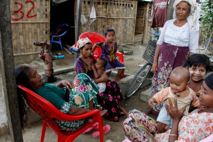 Family members of Rohingya gather in front of their hut at an Internally Displace Persons (IDPs) camp near Sittwe of Rakhine State, western Myanmar, 22 March 2016.  Photo: Nyunt Win/EPA
