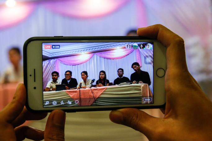 (File)   A journalist broadcasts live report of a  press conference of family members and lawyers of jailed Reuters  journalists Wa Lone and Kyaw Soe Oo, in Yangon, Myanmar, 04 September  2018. Photo: EPA
