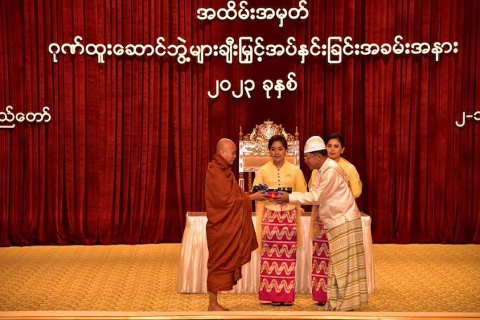 This handout photo taken and released January 2, 2023 by the Myanmar Military Information Team shows hardline Buddhist monk Wirathu (L) being presented an award for "outstanding work for the good of the Union of Myanmar" by military chief Min Aung Hlaing (R) at a ceremony in Naypyidaw. Photo: AFP