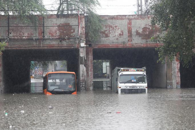 A public transport bus and a truck seen stuck in a Prahladpur water-logged underpass after heavy monsoon rain in New Delhi, India, 19 August 2020. Photo: EPA
