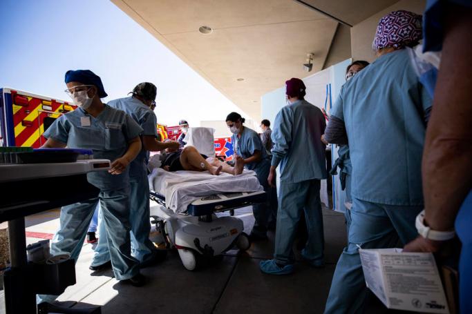 (FILE) Nurses and doctors wearing protective equipment take care of a patient who was brought ambulance after suffering a stroke at the entrance of the ER (Emergency Room) of the Sharp Grossmont Hospital amid the coronavirus pandemic in La Mesa, North of San Diego, California, USA, 22 April 2020. Photo: EPA