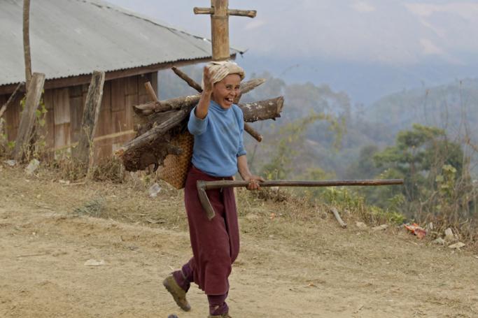 Woman carrying wood in Homain village, Nansam Township, Northern Shan State, Myanmar. Photo: Nyein Chan Naing/EPA